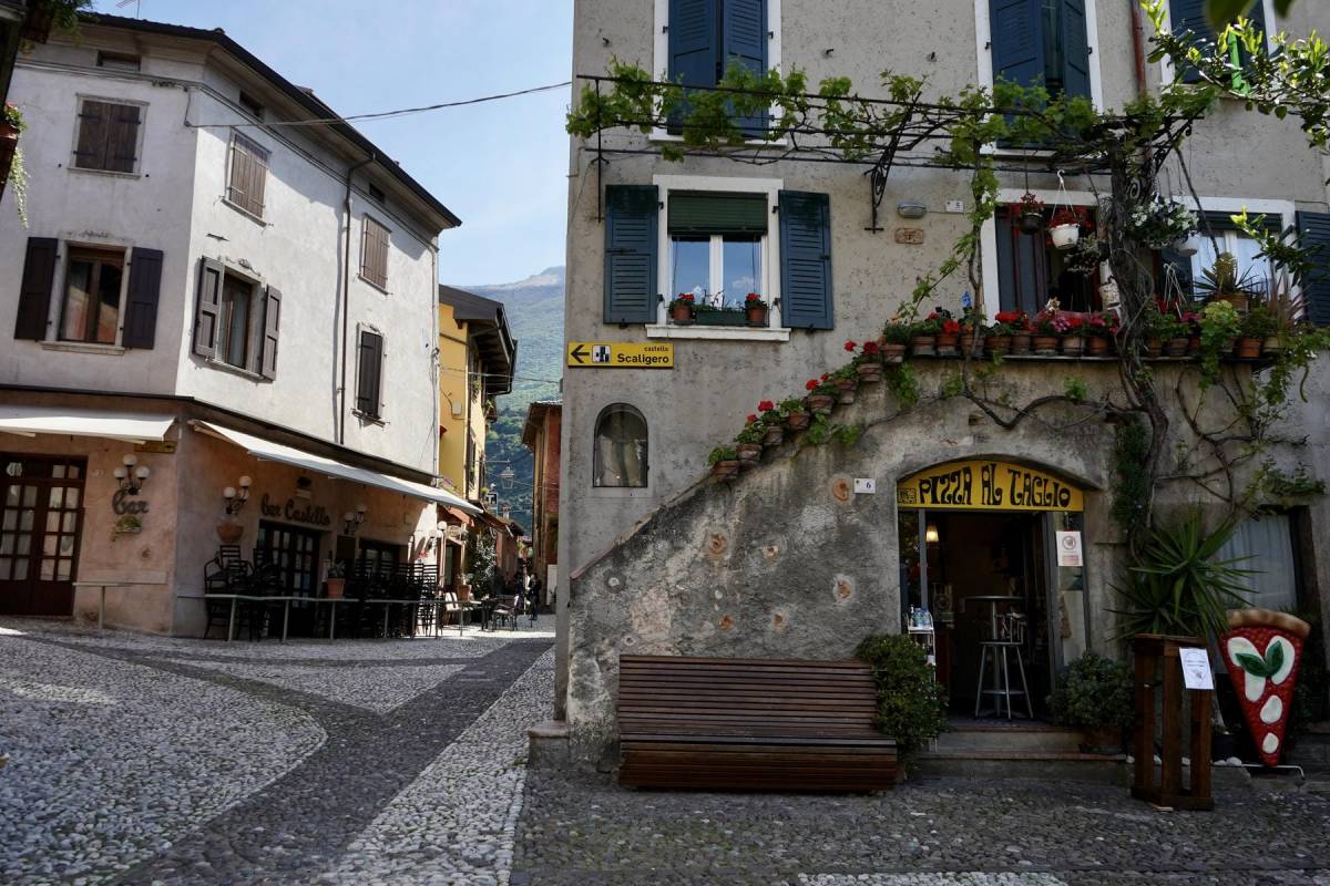 Historic centre of Malcesine with a sign pointing to Castello Scaligero